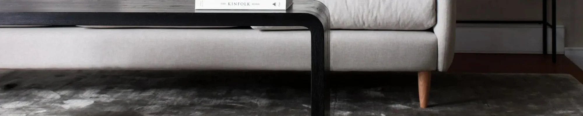 White couch and black coffee table on a brown hardwood floor from The Carpet Store in Oklahoma City, OK